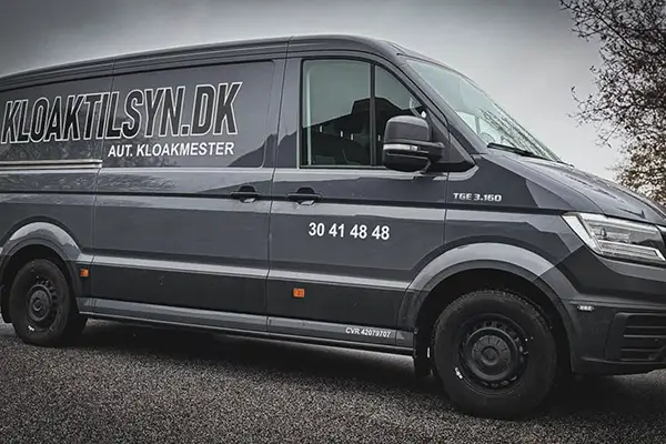 Servicevogn fra Kloaktilsyn.dk med kontaktoplysninger parkeret klar til kloakarbejde og inspektion